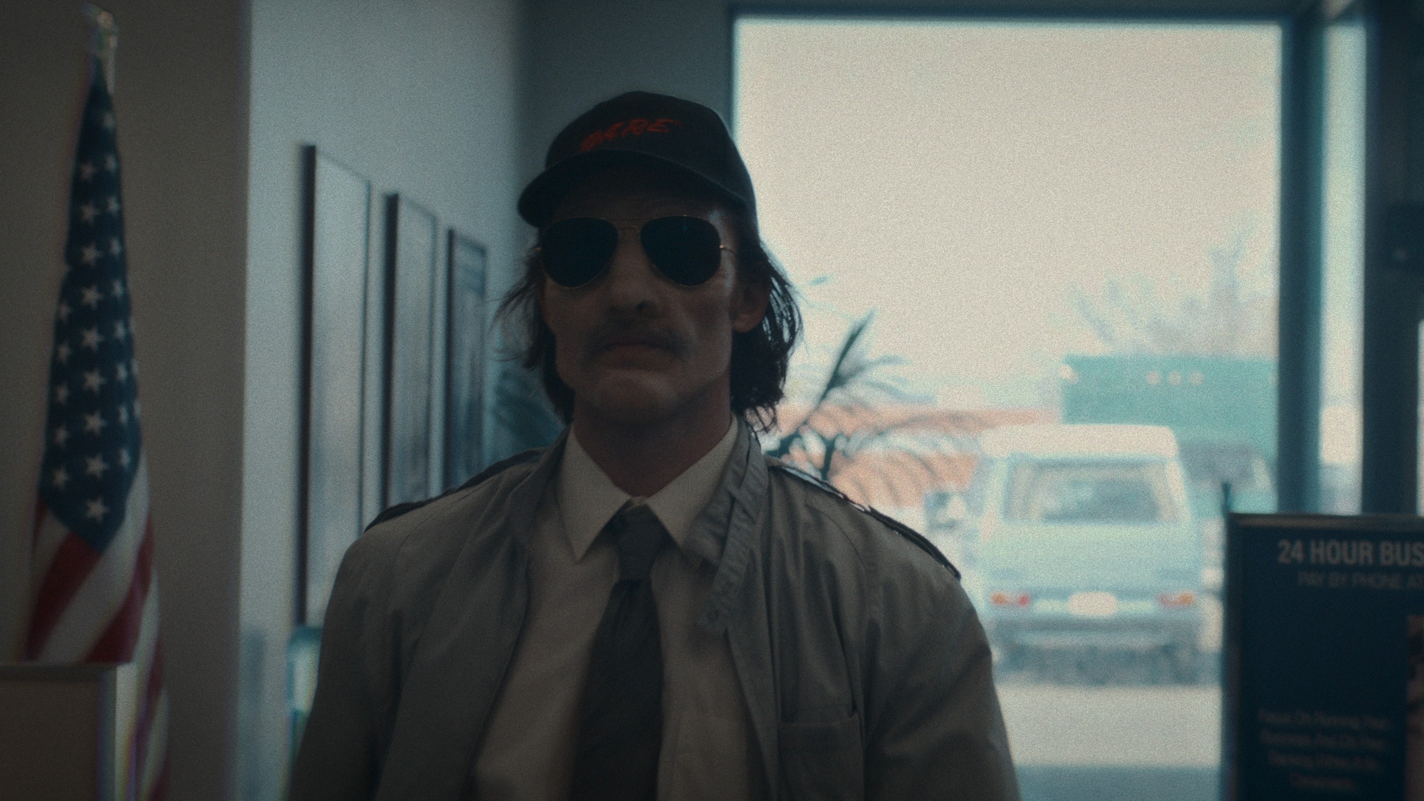 Jordan Burtchett in a hat and sunglasses in How to Rob a Bank