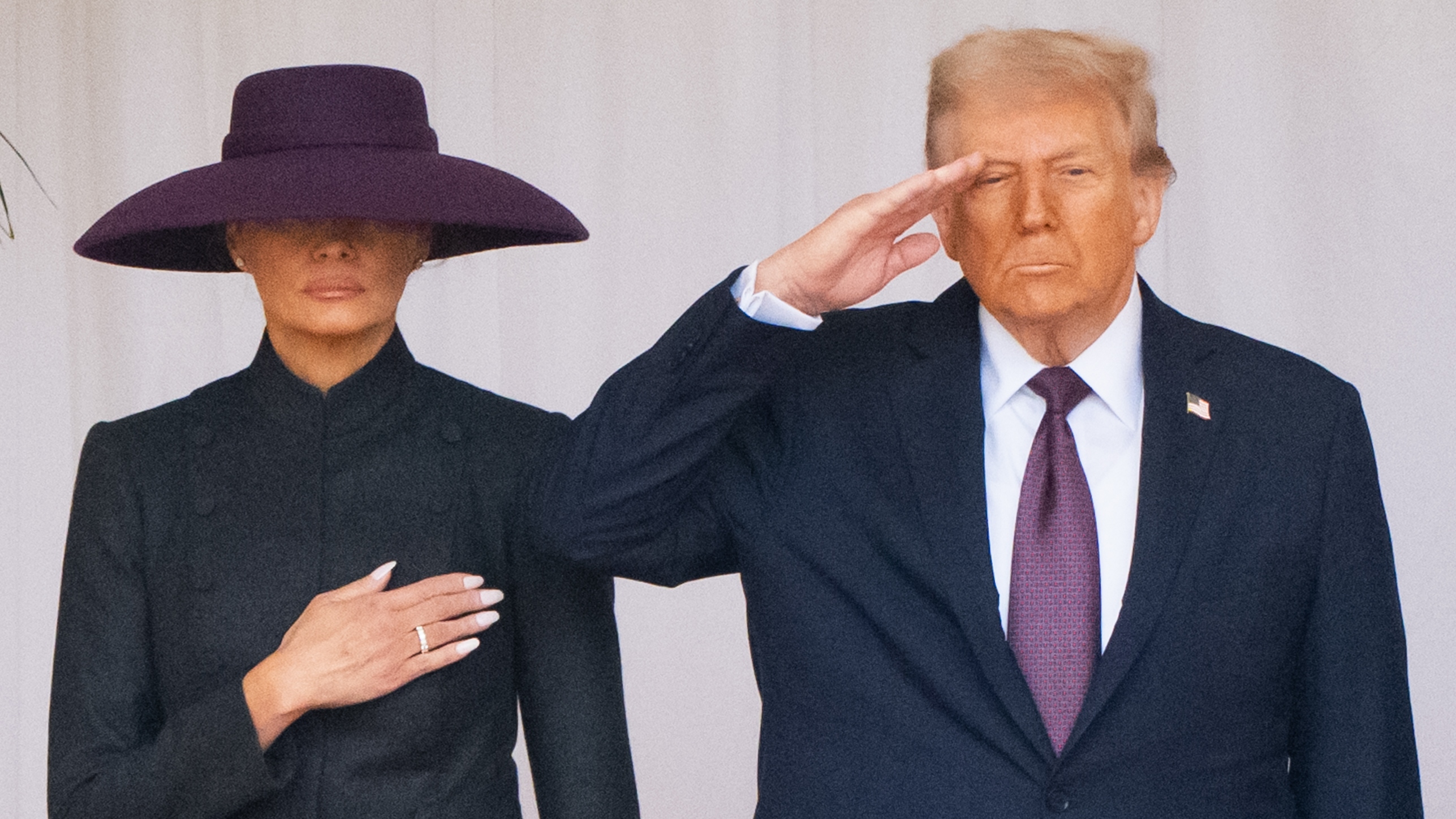 First Lady Melania Trump stands with her hand on her chest and US President Donald Trump salutes at Windsor Castle on September 17, 2025