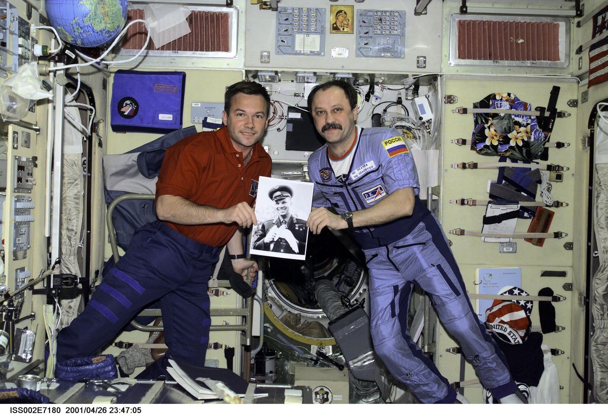 In 2001, Russian cosmonauts Yuri V. Lonchakov and Yury V. Usachev hold a photo of the late cosmonaut Yuri Gagarin for a photo aboard the International Space Station to mark the 40th anniversary of Gagarin's spaceflight on April 12, 1961.