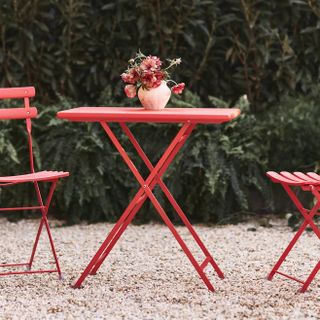 Red metal folding table and chairs