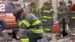 new york september 11 firefighter gerard mcgibbon, of engine 283 in brownsville, brooklyn, prays after the world trade center buildings collapsed september 11, 2001 after two hijacked airplanes slammed into the twin towers in a terrorist attack that killed some 3,000 people photo by mario tamagetty images