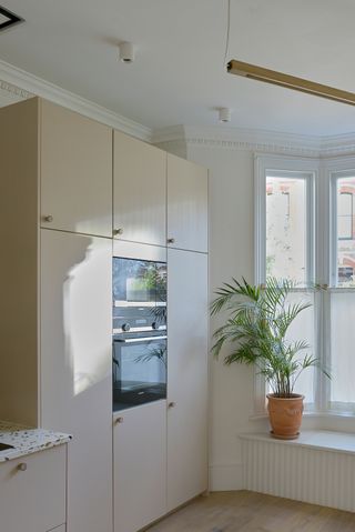 A small kitchen with seating under the bay window