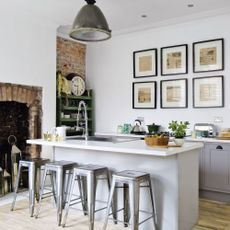 White kitchen with bar stools and minimalistic décor