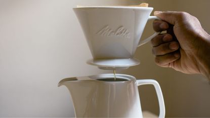 Melitta pour-over coffee maker brewing coffee into a jug