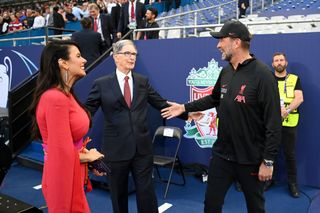 John W. Henry, Owner of Liverpool and wife Linda Pizzuti Henry interact with Jurgen Klopp, Manager of Liverpool prior to the UEFA Champions League final match between Liverpool FC and Real Madrid at Stade de France on May 28, 2022 in Paris, France.