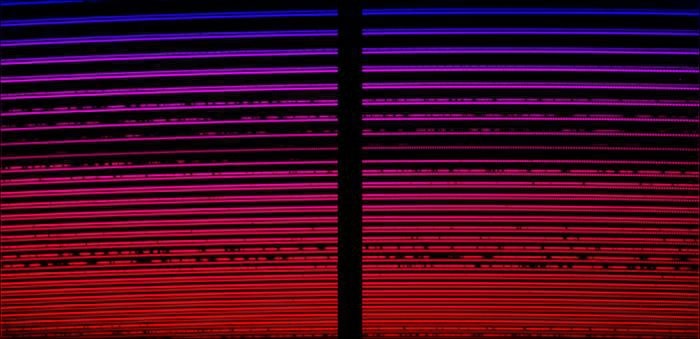 A series of red and purple lines over a dark background