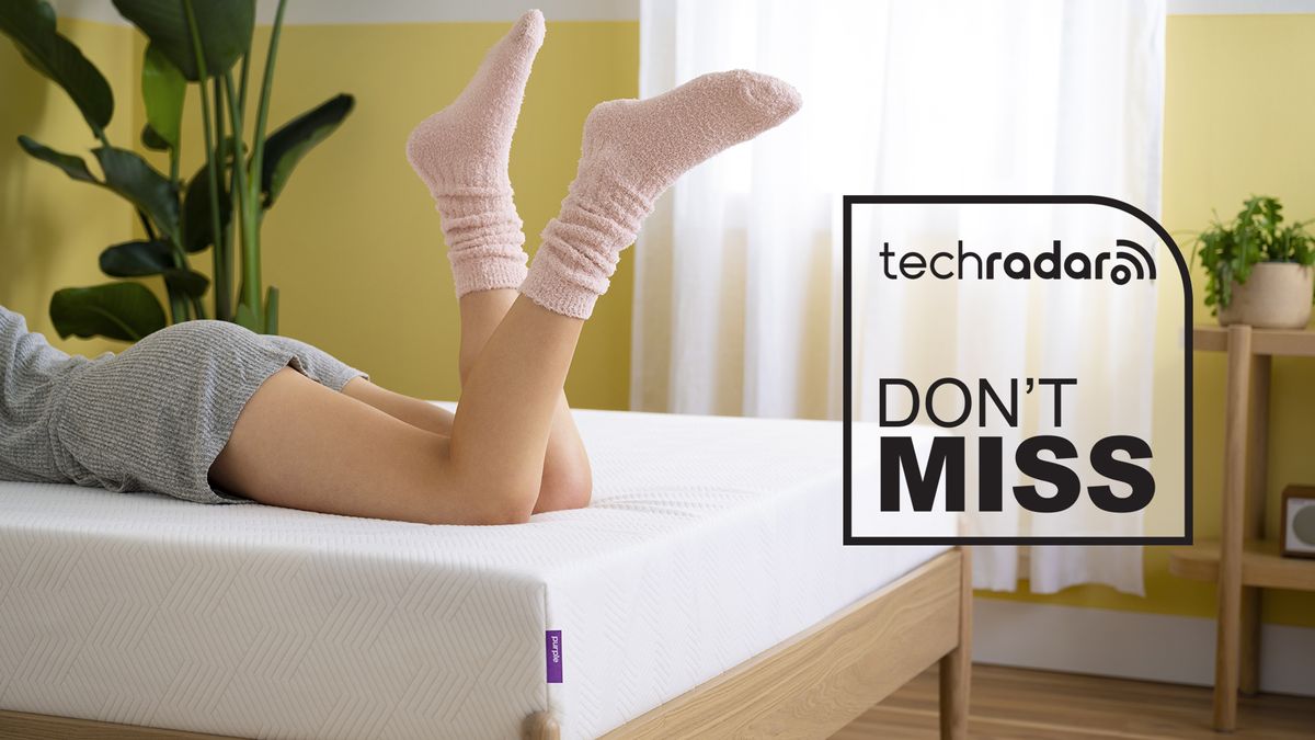 A person lying on a PurpleFlex mattress from the waist down, in the corner is a TechRadar deals graphic