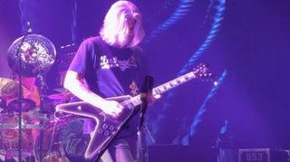 Adam Jones performs onstage with Tool using a Gibson Flying V guitar