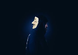 a person with a hacker mask