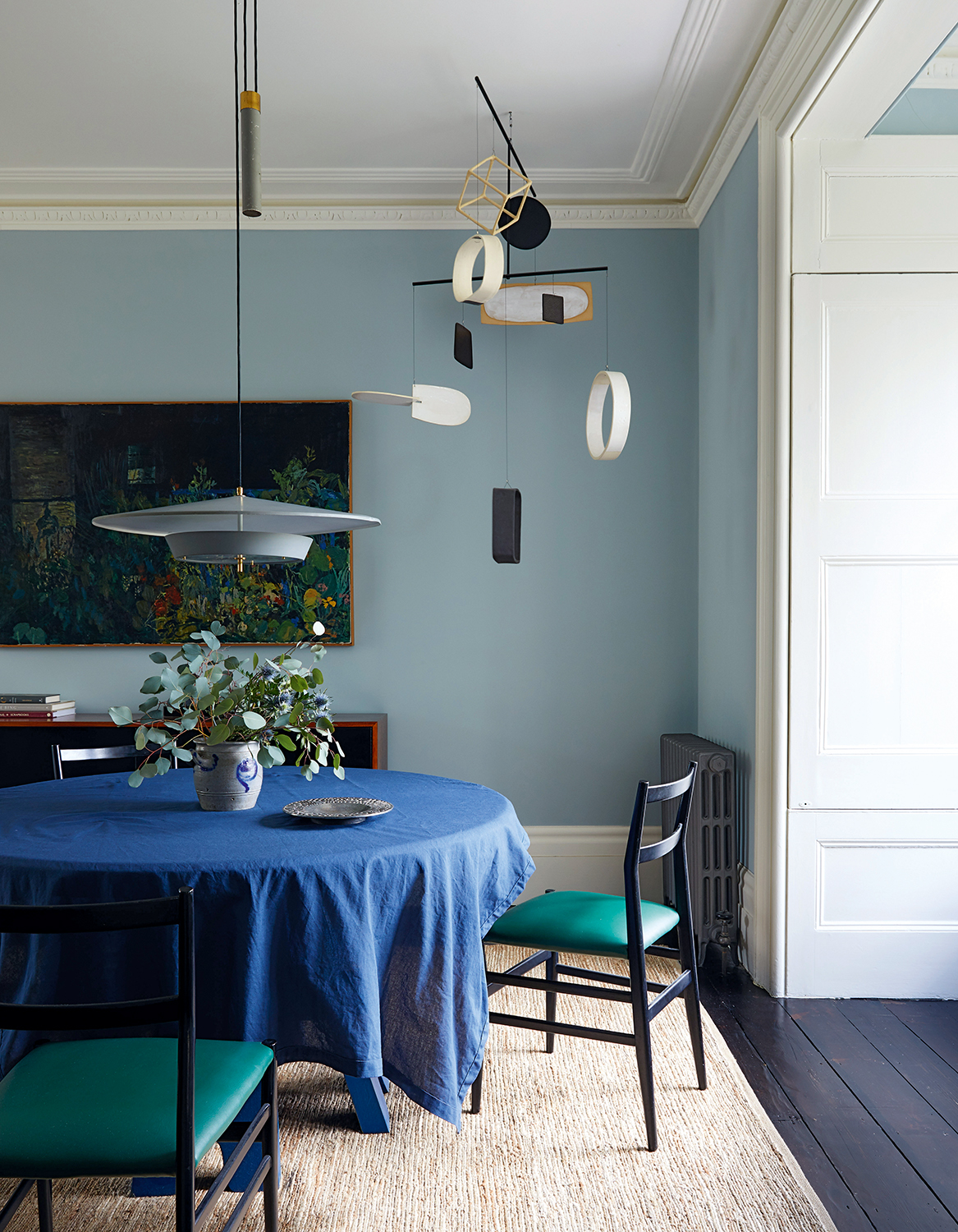 blue dining room with large white light