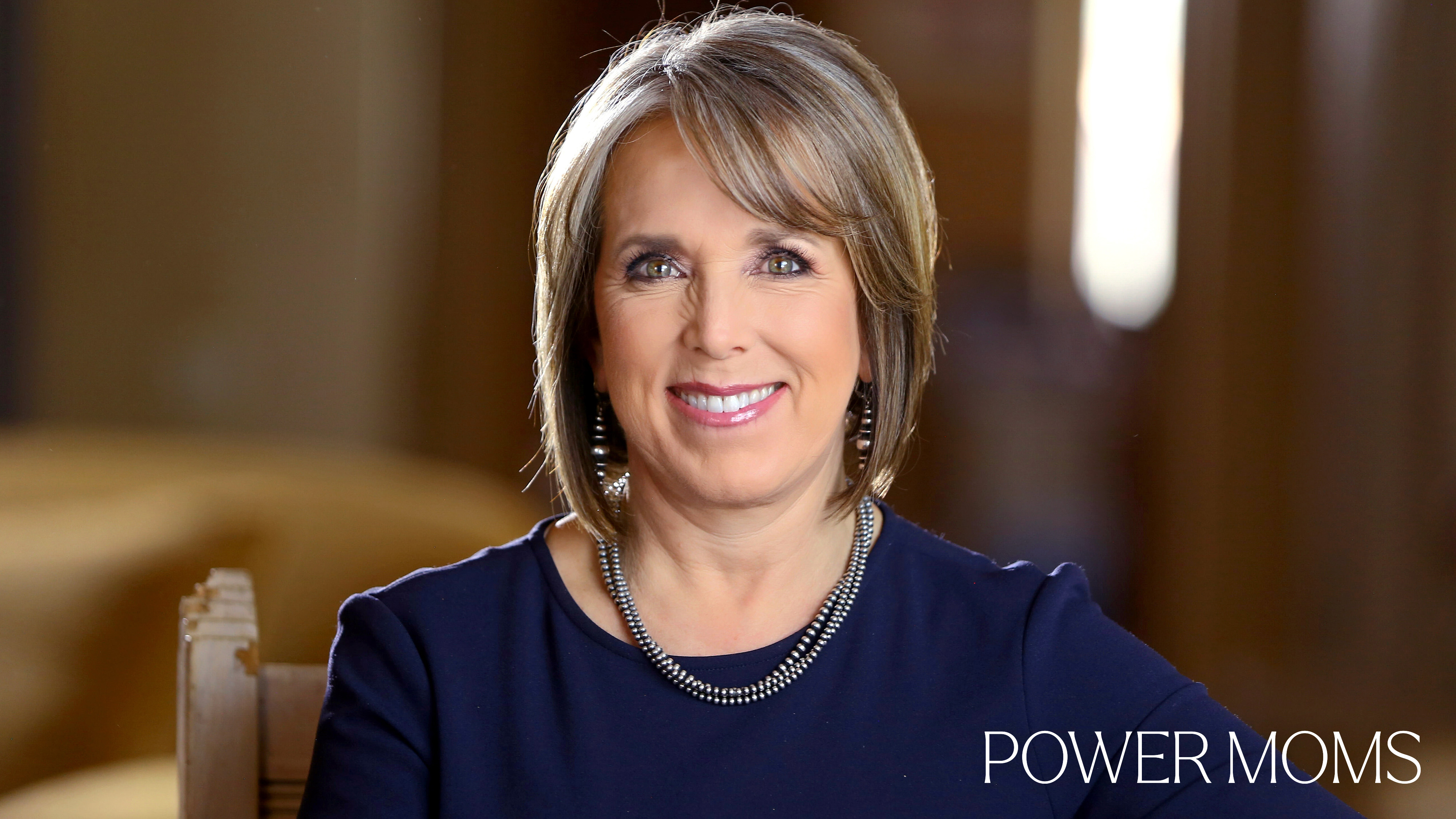 Michelle Lujan Grisham with the text Power Moms overlaid
