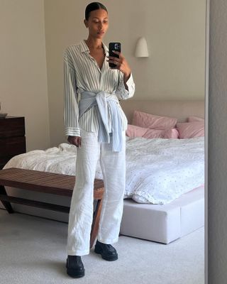 Tylynn Nguyen in a striped button down and white linen trousers