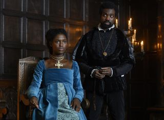 A pregnant Anne Boleyn (Jodie Turner-Smith) sits in the palace with brother George (Paapa Essiedu) standing by her side