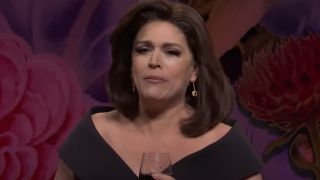 Cecily Strong drinks a glass of wine on SNL during a sketch where she plays Jeanine Pirro.