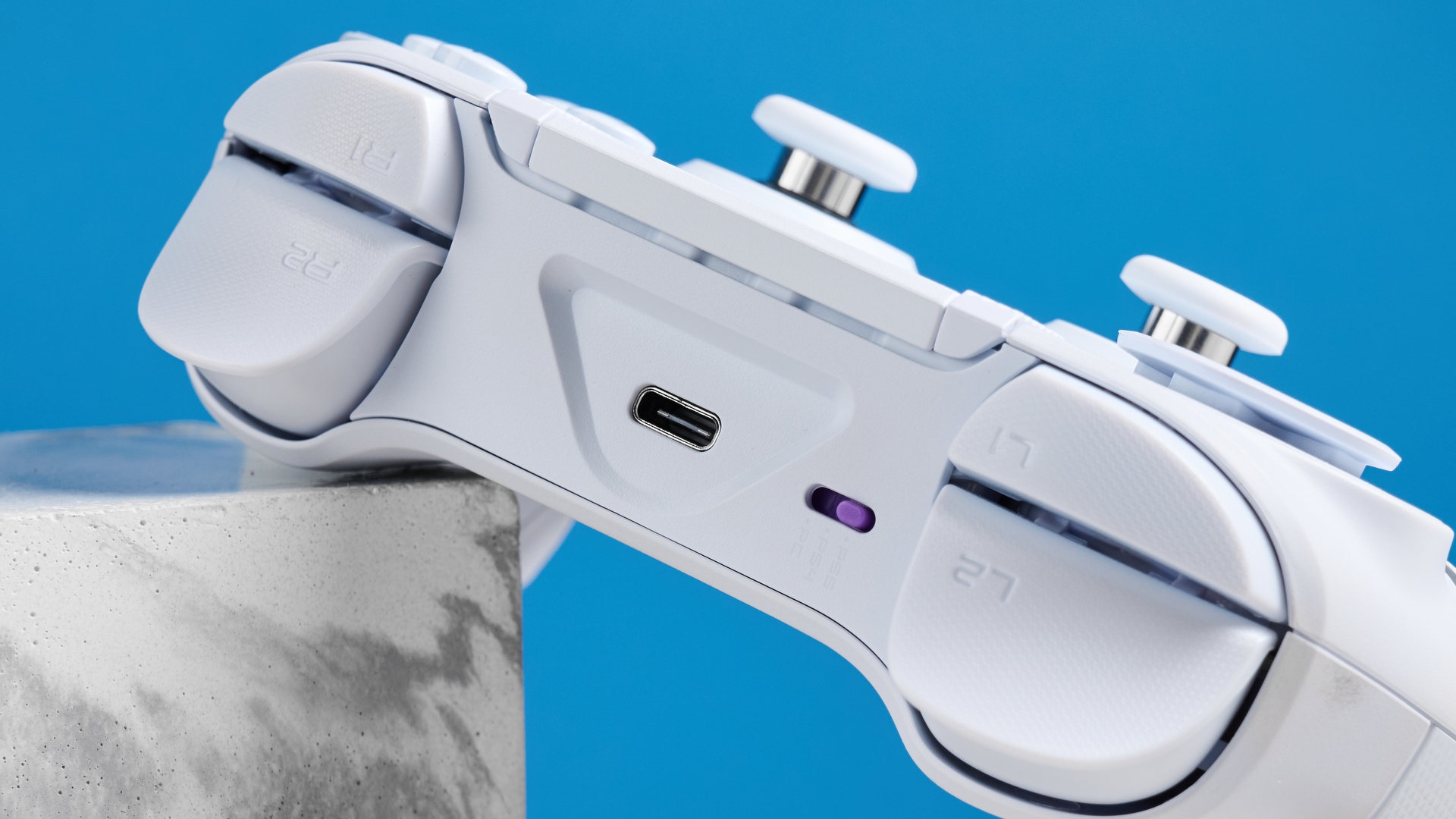 A white Turtle Beach Victrix Pro BFG Reloaded controller for the PS5