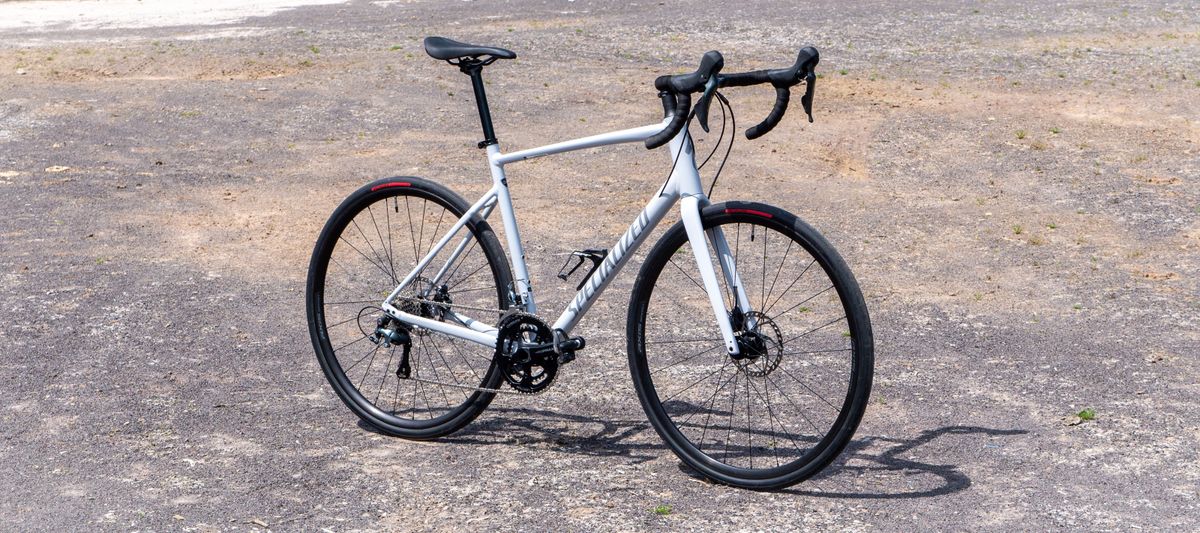 A white specialized Allez stands on rocky ground