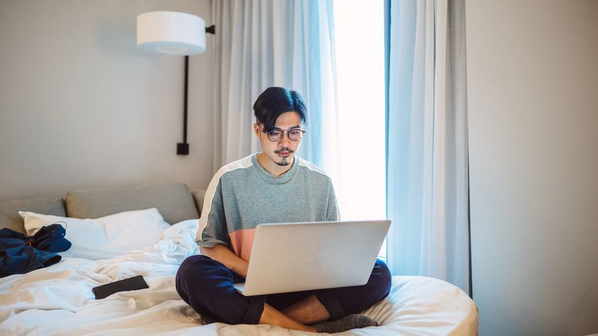 Man uses a laptop in a hotel room