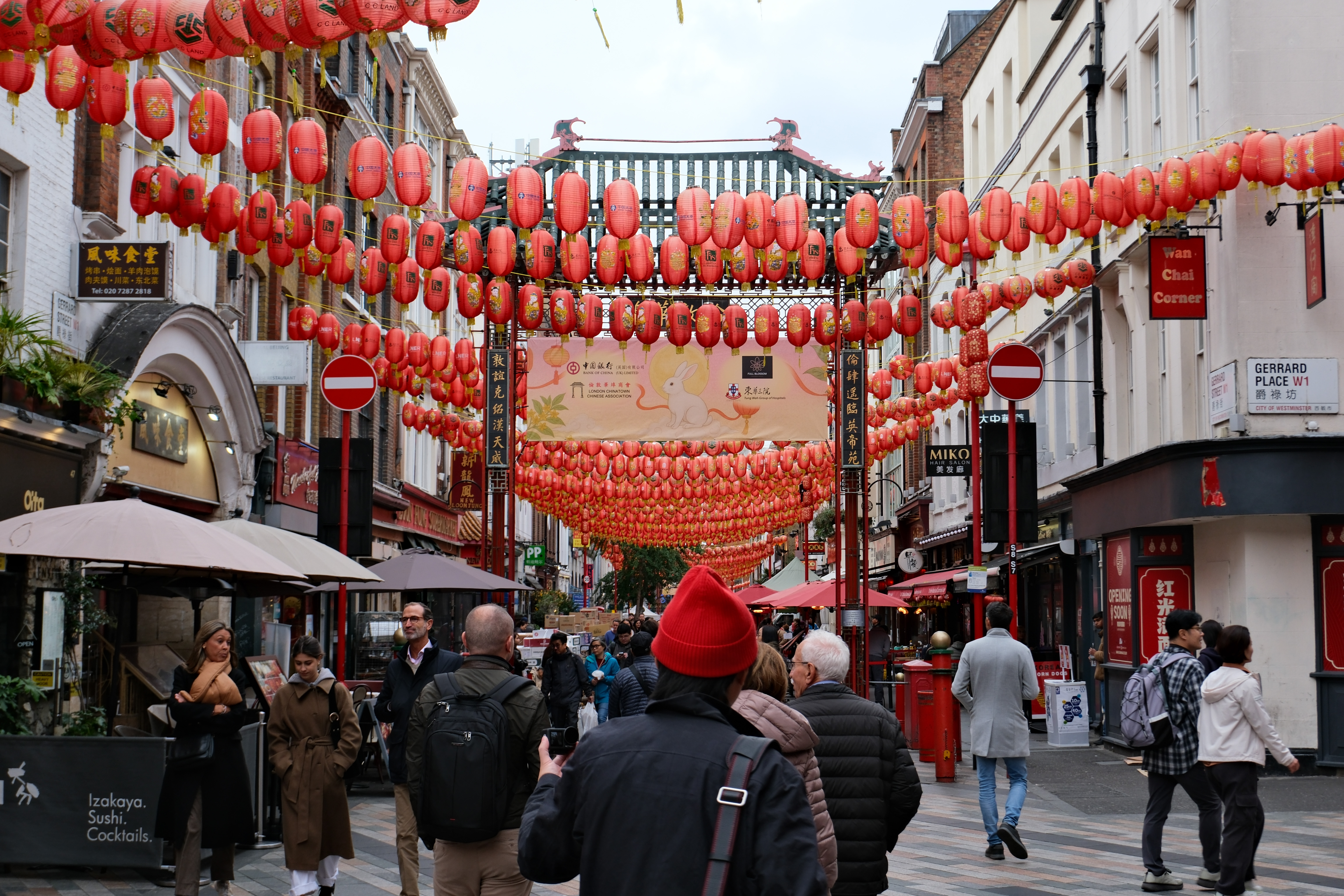 Ornate arch leading into Chinatown in London with paper lanterns across the street