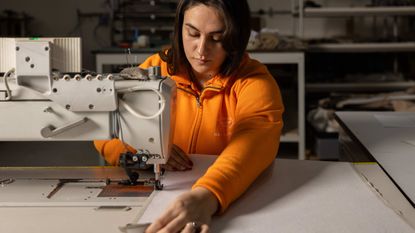 craftsperson working at a sewing machine