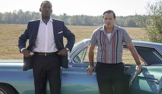 Green Book Mahershala Ali and Viggo Mortensen standing in a field in front of their car