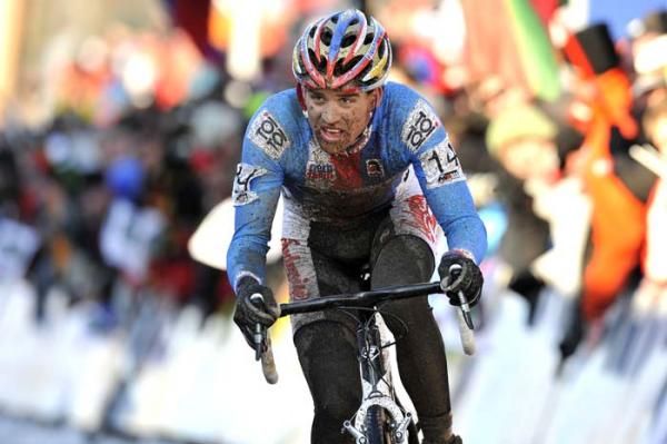 Zdenek Stybar, spattered with mud, rides to victory.