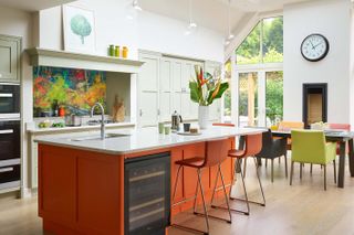 a kitchen island painted in bright orange