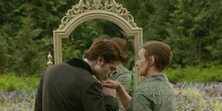 Robert Pattinson as Edward Cullen kissing the hand of Bella Swan as an old lady in a Twilight: New Moon dream sequence