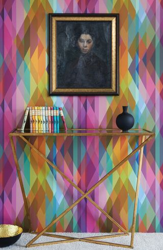 Cole & Son prism wallpaper with metal side table and dramatic wall art