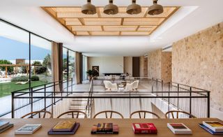 Dining area and open living room with large windows at Sabina Estates Villa