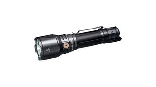 A Black flashlight lies horizonatally with the head facing towards the left on a white blank background