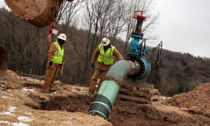Employees of Cabot Oil and Gas work on a natural gas valve at a hydraulic fracturing site in South Montrose, Pa.