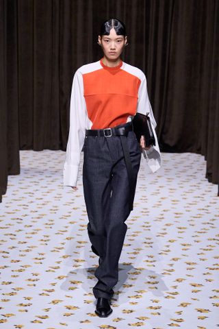 Model wears indigo jeans on the Jil Sander Spring/Summer 2025 runway.