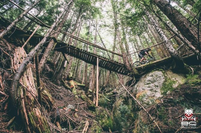 A rider crosses a bridge