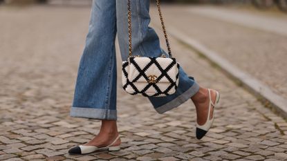 a woman walking with a Chanel handbag - best Chanel perfume