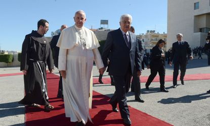 Pope Francis walks with Palestinian President Mahmoud Abbas