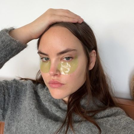 Woman wearing skincare eye patches