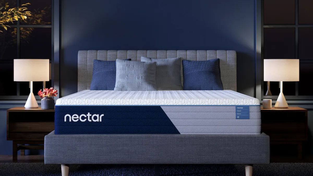 The Nectar Classic Hybrid mattress on a bed frame in a minimalist bedroom