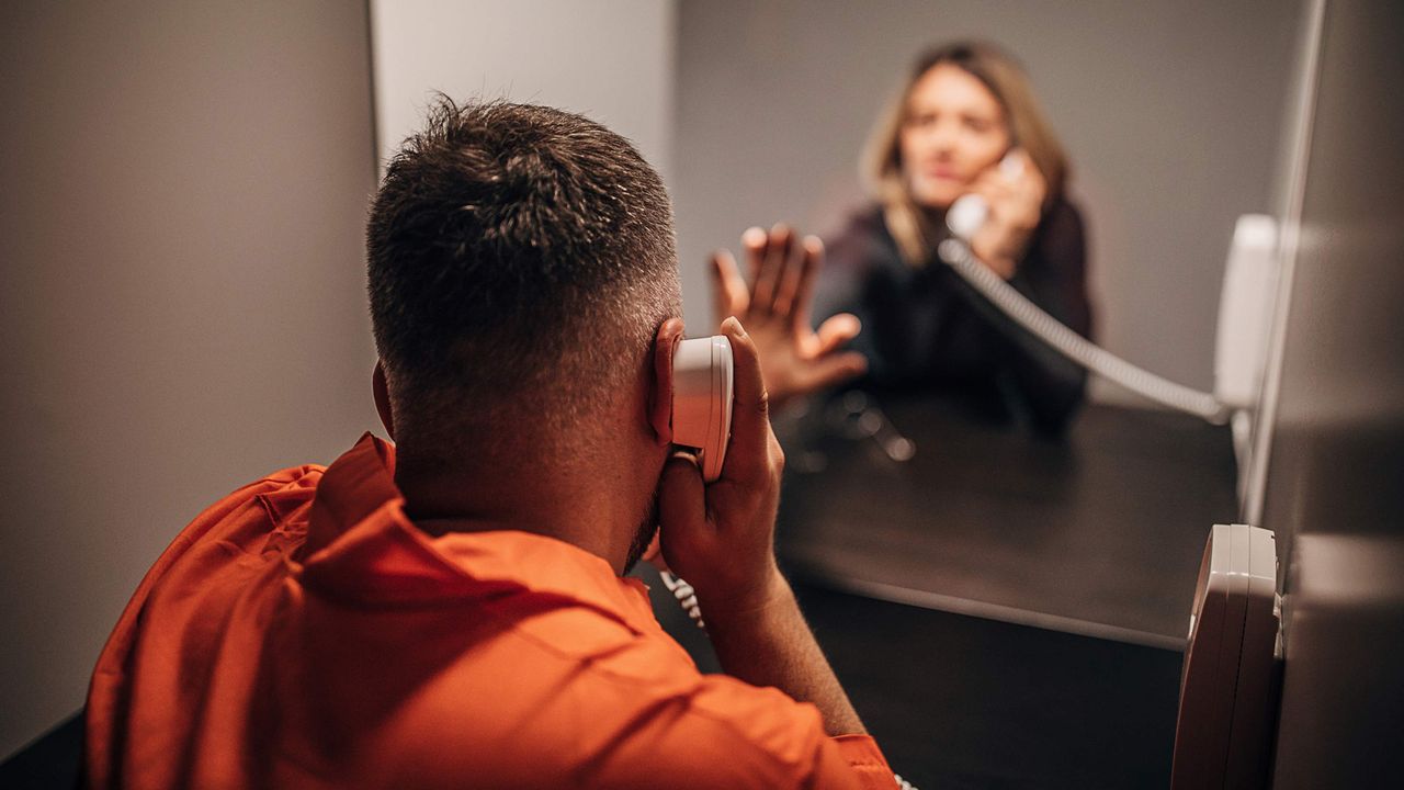 A woman visits her husband in prison.