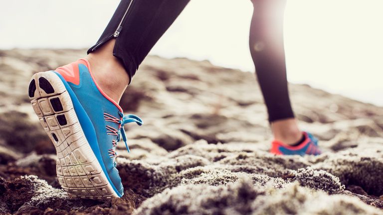 blue pair of running sneakers during a run