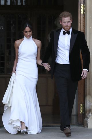 Meghan Markle and Prince Harry on their wedding day, when Meghan also wore a white halter neck gown