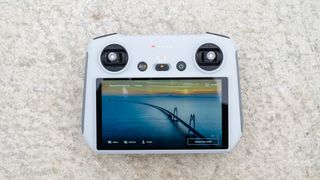 DJI Mavic 3 Classic RC coltroller on a table with the screen turned on