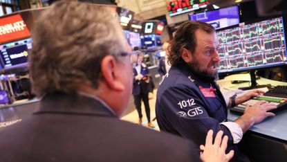Traders on the floor of the New York Stock Exchange as Credit Suisse shares fell on Wednesday 
