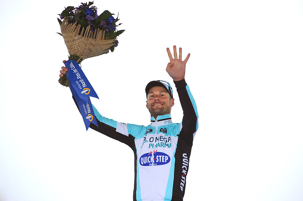 Tom Boonen holds up four fingers to celebrate his fourth Paris-Roubaix victory on the podium in 2012