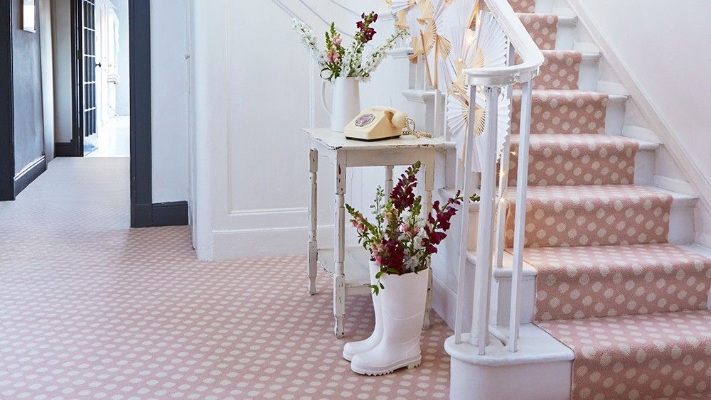 white walls with stairs and carpet on flooring