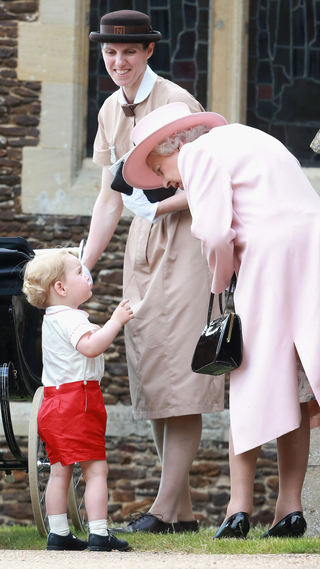 Prince George of Cambridge talks to Queen Elizabeth II outside the Church of St Mary Magdalene on the Sandringham Estate for the Christening of Princess Charlotte of Cambridge on July 5, 2015 in King's Lynn, England