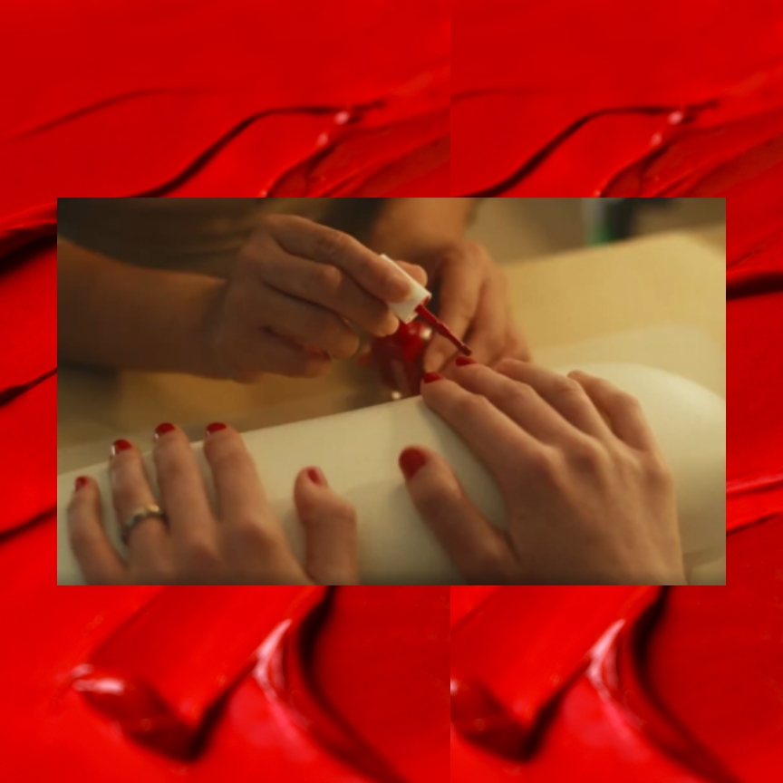 A red background with a still of a woman getting a red manicure