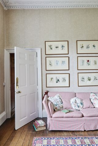 sitting room with striped sofa and flower paintings in a Georgian home