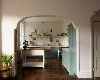 kitchen with archway and green cabinets