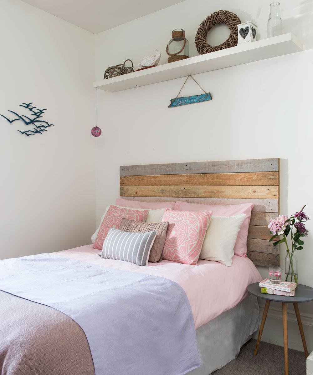 white bedroom with bed and pink pillows