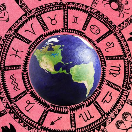Image of globe inside pink astrology wheel with astrology signs and symbols
